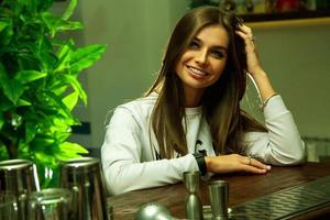 woman with green eyes and charming smile looking at the camera photo