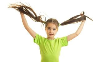 little schoolgirl holds tails and smiling photo