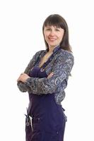 cheerful female stylist in apron with tools smiles in camera photo