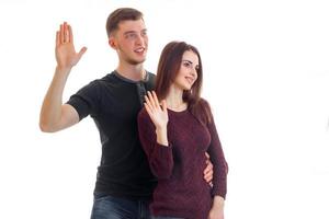 beautiful young couple look aside and show the hand gesture photo