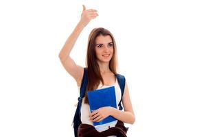 beautiful young girl in white shirt and with a portfolio of smiles and raised her arm up photo