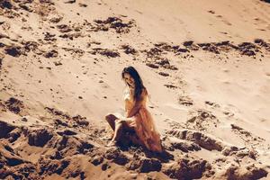 cutie girl in pink dress in desert photo