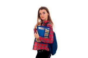 a young girl's shirt in the box stands sideways and holding a folder with notebooks photo