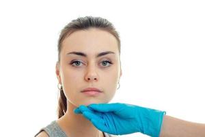 Portrait of a charming young girl without makeup at the doctor in a blue glove photo