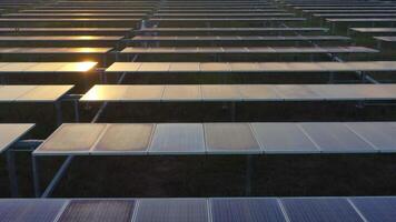 Aerial view from drone flying over solar panels stand in row, green energy landscape electrical power ecology innovation nature environment video