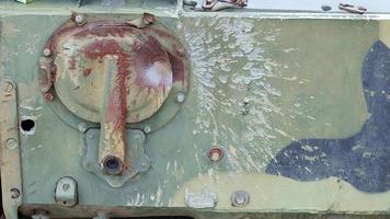 Hole or hole, armor deformation from a projectile close-up. Damaged armor of a Russian armored personnel carrier by shell fragments. War in Ukraine. Russian combat vehicle with holes in the armor. video