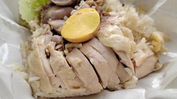 Close up Hainanese chicken rice wrapped in paper. popular food in Thailand video