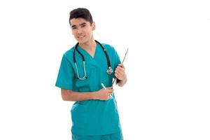 young male doctor in uniform with stethoscope posing isolated on white background photo