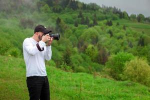 photographer takes mountain landscape photo