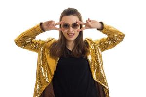 wonderful bright girl in glasses and a gold jacket posing in Studio photo