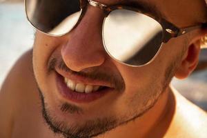 close up portrait of a happy man in sunglasses photo