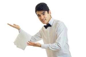 young friendly waiter smiles at the camera photo