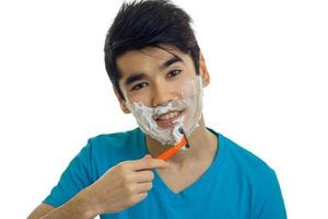 close-up portrait of a beautiful fun guy with razor photo