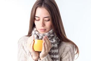 a young girl with  scarf and hot cup in the hands of isolated on white background photo