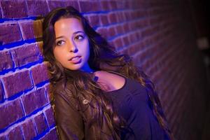 Pretty Mixed Race Young Adult Woman Against a Brick Wall photo