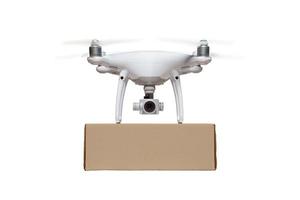 Front View of Unmanned Aircraft System UAS Quadcopter Drone Carrying Blank Package On White photo