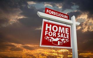 Red Foreclosure Home For Sale Real Estate Sign Over Sunset Sky photo