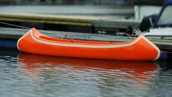 orange canoe at the pier travel concept video