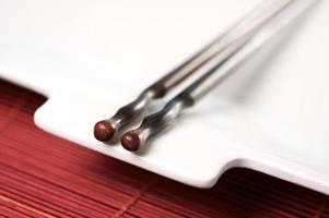 Wooden Chopsticks and White Plate photo
