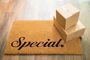 Special Welcome Mat On Wood Floor With Shipment of Boxes photo