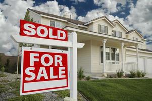 Sold Home For Sale Sign and New Home photo