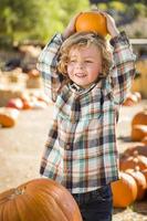 Little Boy Holding His Pumpkin at a Pumpkin Patch photo