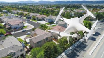 Unmanned Aircraft System Quadcopter Drone In The Air Over Residential Neighborhood. photo