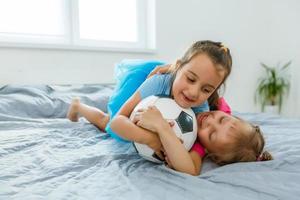 little girls with soccer ball at home photo