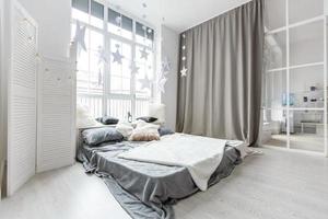 Gray bedroom with big window, double bed in scandinavian style photo