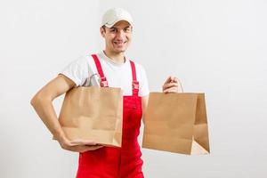 paper containers for takeaway food. Delivery man is carrying photo