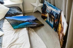 wall art canvas in three parts. Sofa, lamp, plant and table in room interior. photo
