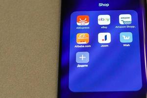eBay, Amazon, AliExpress and Alibaba apps icon on the screen smartphone. Closeup mobile applications for shopping, e-commerce. Kyiv, Ukraine - November 10, 2019 photo