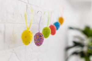 Easter eggs hanging on the clothesline isolated on white photo