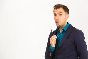 A view of a shocked young businessman isolated on white background photo