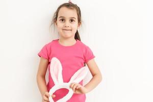 Happy lost tooth little girl wearing funny bunny ears photo