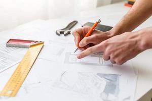 Hands of Engineer working on blueprint Construction concept. Engineering tools.Vintage tone retro filter effect,soft focus photo