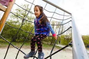 Active little girl on playground photo