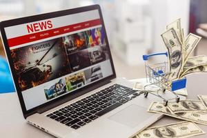 The word 'News' in a shopping trolley against red background photo