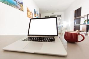 Laptop with blank screen . Home interior or office background photo