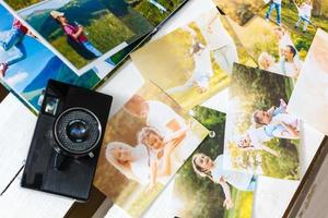 vintage camera and old photos on wooden background. nostalgic style picture