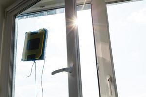 Detail of a glass cleaning robots acting behind a window photo