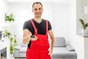 homeowners getting key to new house apartment, family mortgage investment and buying property concept, close up view of hands photo