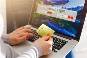 Flights online booking and reservation. woman working with a computer, search flights on the screen, office business background. photo