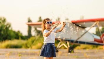 sweet little girl near the plane photo