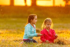 two little girls walking in the field. photo