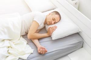 Serene man sleeping in his bedroom photo