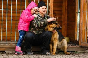 Senior man with his granddaughter. Child and grandpa outdoors. Benefits of getting older photo