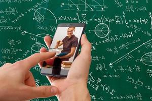 Man use mobile phone,blur image of classrooms are empty as background. photo