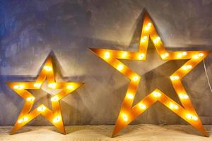 Decorative star with lamps on a background of wall. Modern grungy interior photo