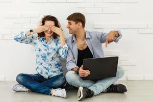 Portrait of happy young couple using laptop isolated photo